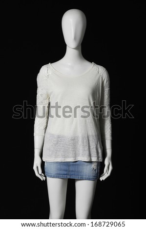 mannequin in shirt dress and shorts on black background