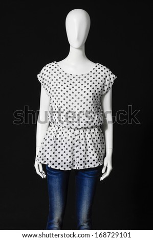mannequin in female dressed in shirt and jeans on black background