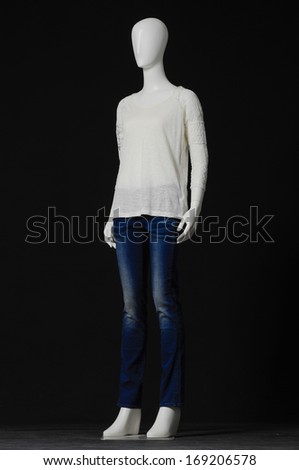 full-length Mannequin female dress and jeans isolated on black background