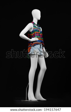 full-length mannequin female dressed in shirt and short on black background