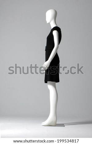 Side view Mannequin dressed in black dress on gray background