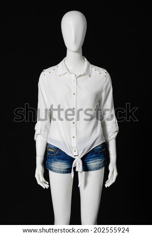 female mannequin in white shirt dress and shorts on black background