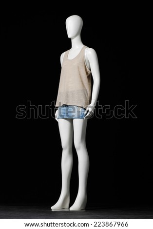Full length mannequin female dressed in shirt and short on black background