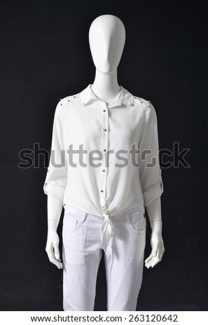 Mannequin female shirt and white trousers on black