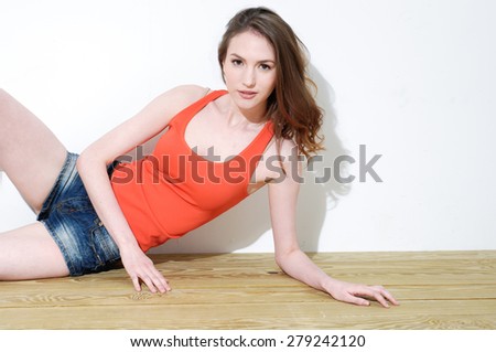 female model and shorts jeans sitting on the wooden floor