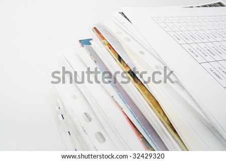 Big pile of different coloured office papers in files and folders on white background