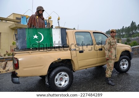 Swat, Pakistan - September 17, 2014: Soldiers ready for patrol in Swat Valley. In May 2009 the Pakistan Army fought Taliban militants in the Valley. The Army maintains a presence in its main towns.
