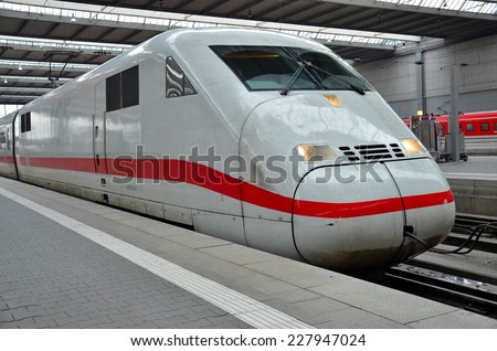 Munich, Germany - November 11, 2012: A red and white ICE Deutschebahn bullet train locomotive waits to depart at Munich Bahnhoff train station.