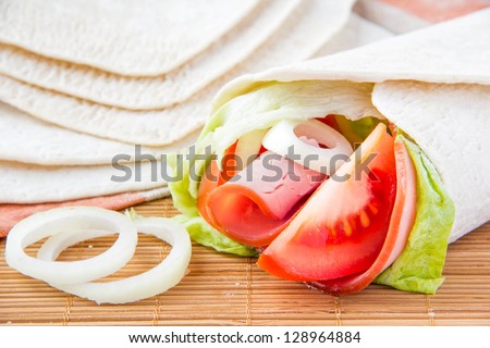 Fresh tortilla with vegetables and ham