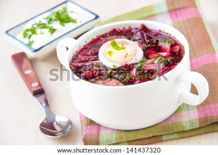 Traditional cold Lithuanian summery soup made of beets, cucumbers and herbs with egg and cream