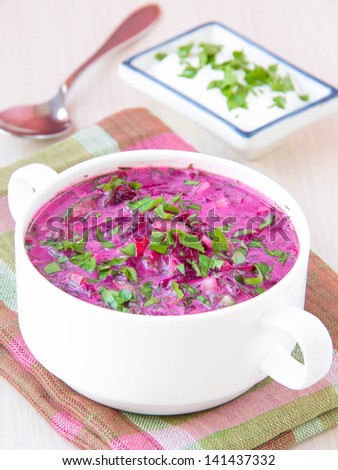 Traditional cold Lithuanian summery soup made of beets, cucumbers, egg and herbs in white plate