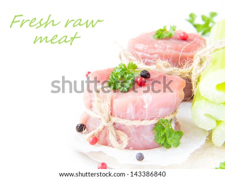 Two isolated fresh fillet of raw meat with spices and herbs on a white background for your text