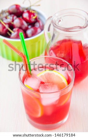Delicious sweet berry juice of cherry in glass and carafe for party