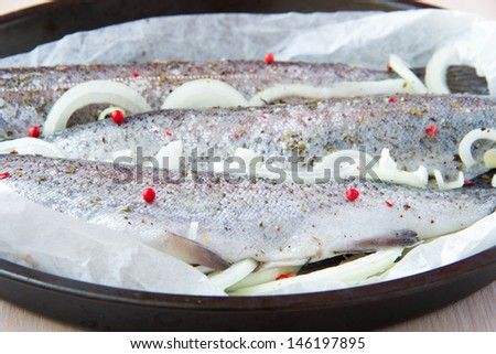 Raw fish rainbow trout prepared for baking in frying pan
