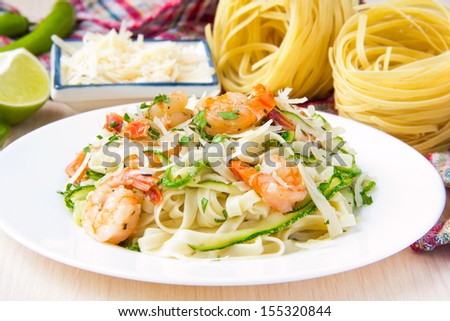 Tagliatelle pasta with fried shrimps, cheese Parmesan, parsley and zucchini ribbons, handmade dish
