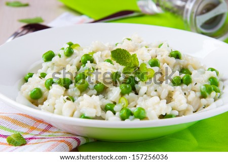 Italian risotto with rice, green peas, mint and cheese, restaurant dish