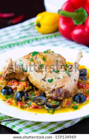 Ragout from stewed legs of rabbit with herbs, vegetables and olives, delicious homemade dinner
