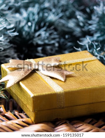 Gift in gold box under tree for Christmas