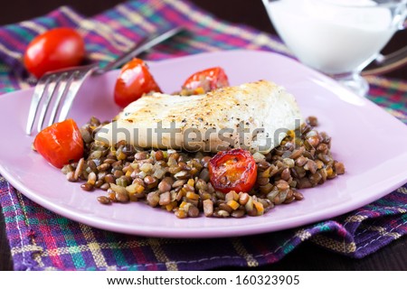Fried fish fillet of perch, cod with vegetables and lentils, tomatoes, homemade dinner