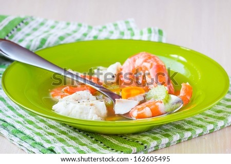 Fish soup with shrimps, white fillet of cod and perch, celery, carrots and broth, diet food