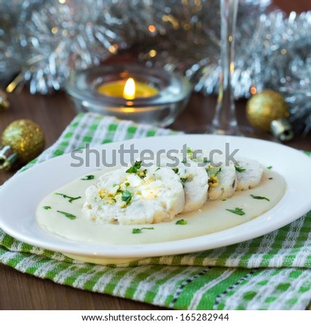 Roulade roll of white fish fillet cod stuffed with egg, sauce bechamel, Christmas holiday appetizer