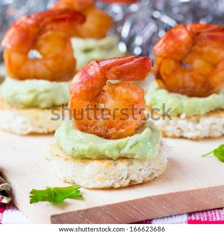 Shrimp on toast with guacamole sauce avocado, Christmas tasty elegant appetizer, starter for new year party