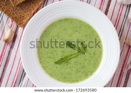 Green garlic cream soup with leaves rukola, arugula, healthy dietary vegetable dish