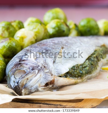 Two fish, rainbow trout stuffed with green herb sauce, Brussels sprouts garnish, delicious dinner