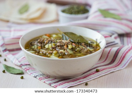 Meat winter soup with beef, mung green beans, legumes, potatoes, hot Indian oriental dish