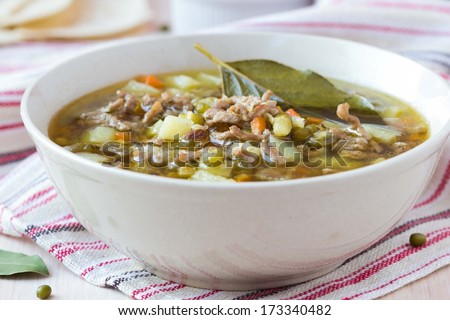 Meat winter soup with beef, mung green beans, legumes, potatoes, hot Indian oriental dish