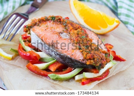 Steak red fish salmon on vegetables, zucchini and paprika with salsa, tasty diet dinner