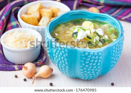 Onion soup with rice, feta cheese, zucchini, croutons, tasty, traditional hot winter dinner