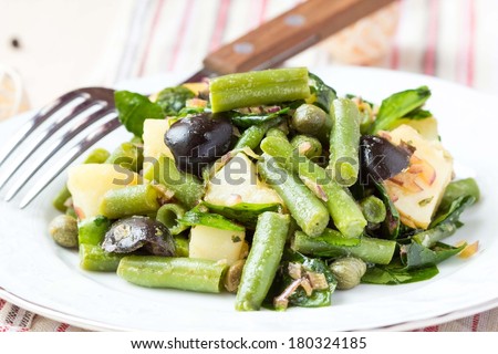 Potato salad with green beans, olives, capers, onions, delicious healthy diet rustic lenten dinner