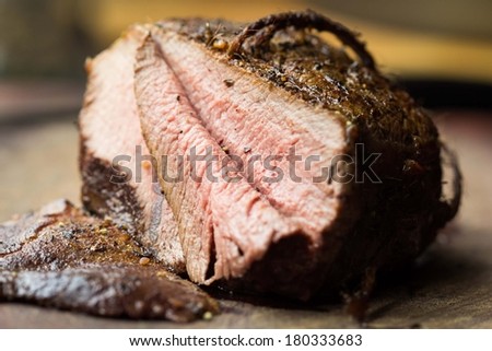 Piece of roasted juicy beef, veal, cut in slices, delicious homemade dinner