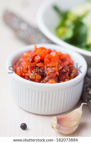 Salsa sauce with dried tomatoes, red pepper, oil, garlic and herbs, cooking in kitchen