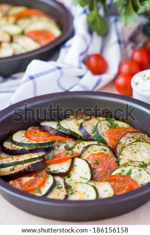 Ratatouille, vegetables cut into slices, eggplant, zucchini, tomatoes baked in oven