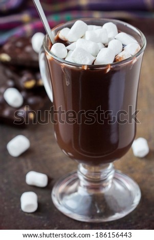 Drink hot chocolate with marshmallows in transparent glass, tasty sweet