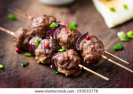 Meat kebab, beef balls on skewer with onions, avocado sauce guacamole, spring picnic