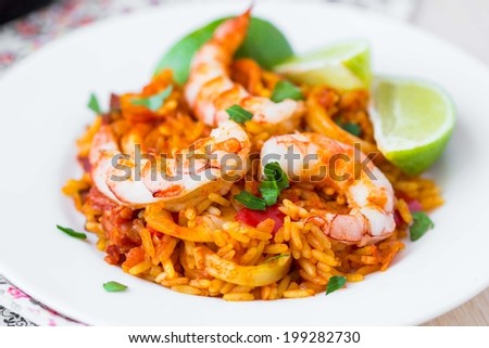 Spanish dish paella with seafood, shrimps, squid, rice, saffron, traditional tasty dinner