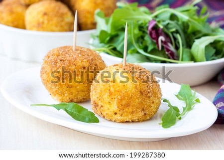 Italian appetizer arancini, rice balls stuffed with meat cooked in deep fat