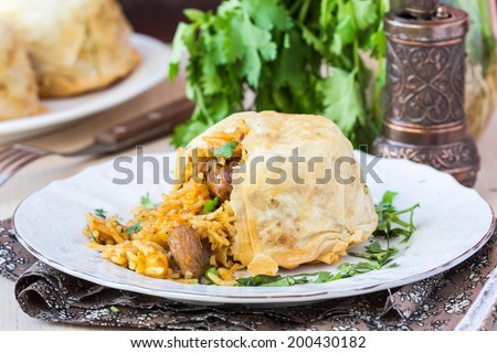 Oriental shah pilaf, pilaw, plov, rice with meat in pastry filo, delicious fragrant spicy dish