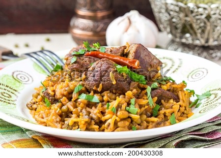 Plov, pilaf with rice, meat, beef, mutton, beans mash, delicious oriental dish