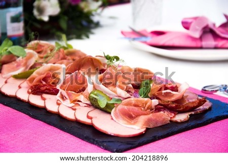 Meat plate on table, snacks for party, elegant presentation