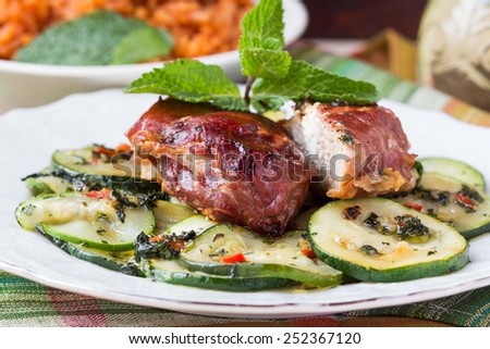 Pork steak, meat stuffed with feta cheese with bacon pancetta and zucchini salad