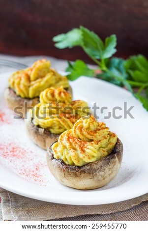 Stuffed caps  mushroom champignon yellow mousse lentils, tasty snack, appetizer