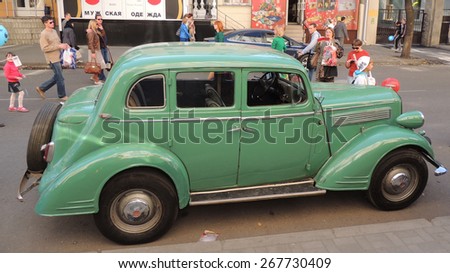 Voronezh, Russia - September 20, 2014:  city dwellers look round retro car on the street in the city core during the celebration of the City Day