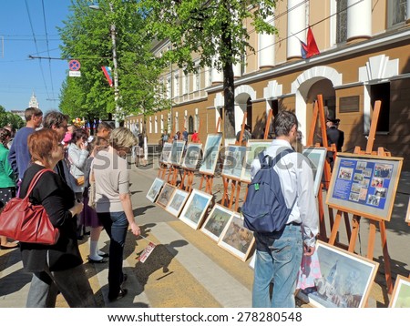 Voronezh, Russia - May 9, 2015: City dwellers looking paintings on the street art exhibition in the city core on celebration of Victory V-E Day