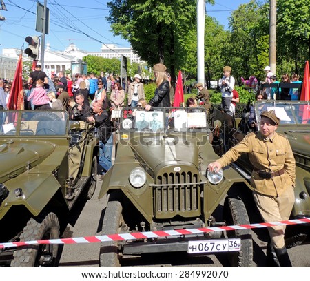 Voronezh, Russia -May 9, 2015: Retro car of World War II soviet military all-wheel-drive light truck jeep GAZ-67. Man near vehicle in the uniform of Polish Army formed in the Soviet Union in 1944