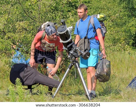 VORONEZH, RUSSIA - July 26, 2015: Young men interested in astronomy at the campground on July 26, 2015 in Voronezh, Russia
