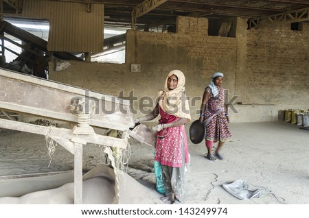 ROURKELA, INDIA - MAY  15,2013 - A Woman worker is separating different sizes of refratories in a small industry on 15th May 2013 in Rourkela,India. She is working without any safety equipment.